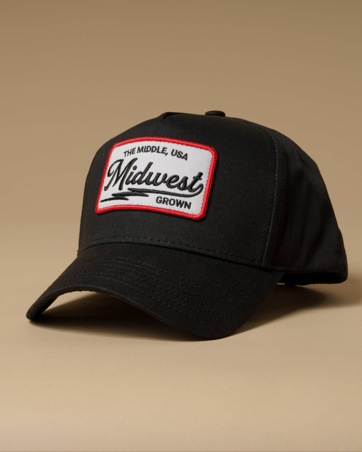 Black, The Middle, USA Hat sitting on a tan background from Midwest Grown