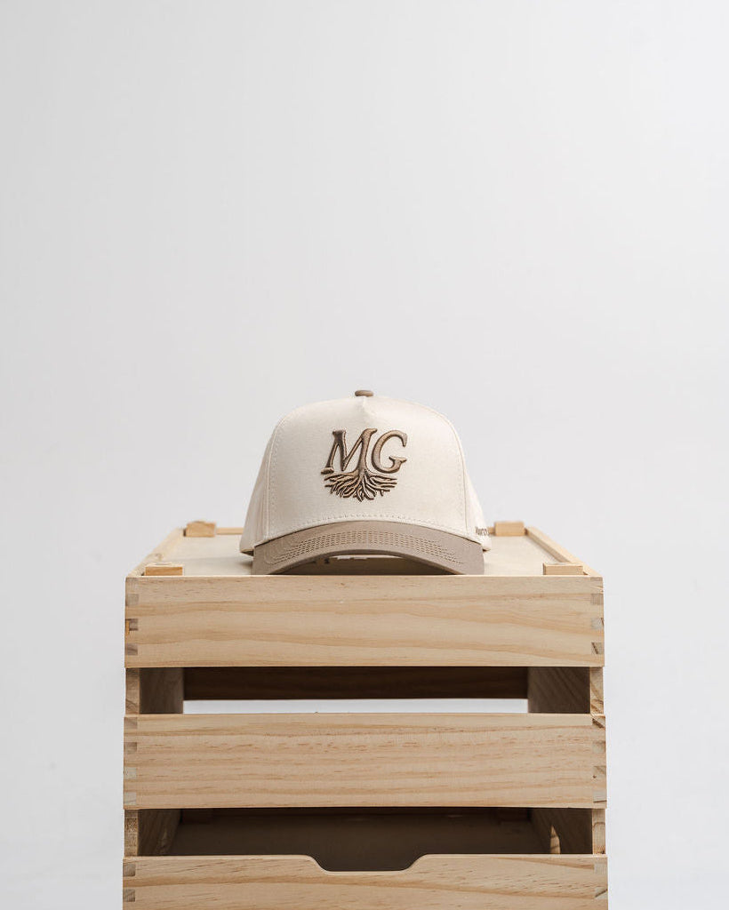 White cap with 'Midwest Grown' logo on a wooden crate against a white background